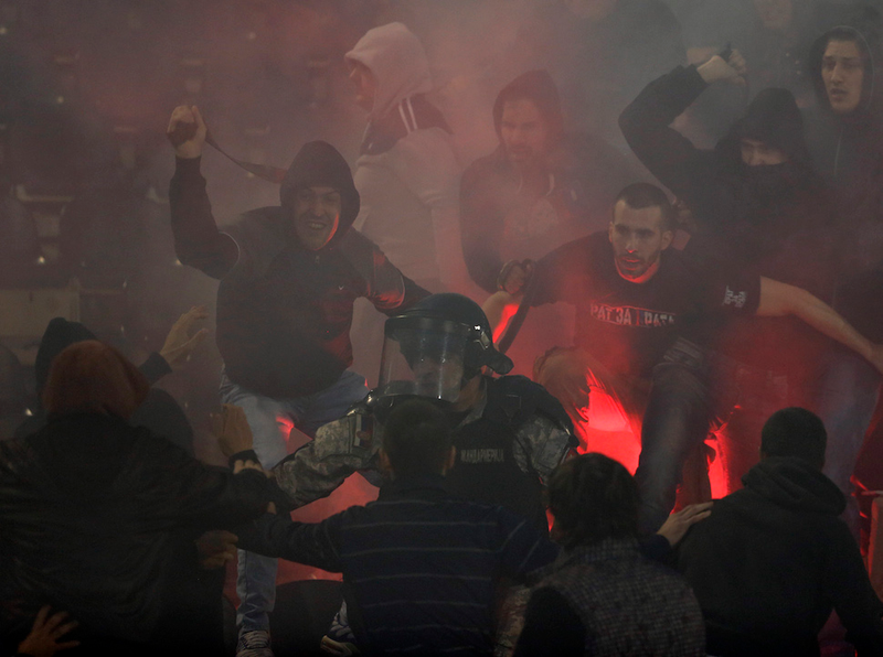 Illustration for article titled Smoke, Flares, Riot Police In Belgrade Derby Make For Haunting Photos